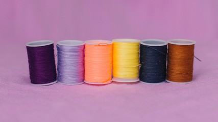 Colored spools of thread for sewing. Needlework.