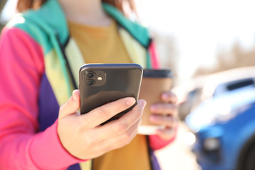MYKOLAIV, UKRAINE - MARCH 16, 2020: Woman holding iPhone 11 Black outdoors, closeup