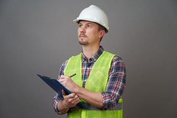 Worker man wearing protective hard hat and reflective vest.