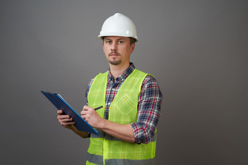 Worker man wearing protective hard hat and reflective vest.