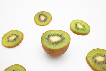 Juicy kiwifruit half and cut slices closeup isolated on white background. Organic food or healthy nutrition concept