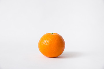 Whole orange fruit isolated on white background. Single object, closeup. Natural vitamin or organic food concept