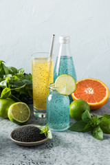Basil seeds beverage with orange and tropical juice. Close up. Vertical format.