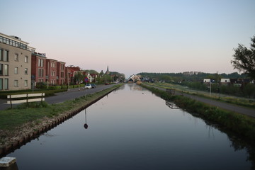 The sun rises over the ring canal of the Zuidplaspolder in the town of Nieuwerkerk aan den IJssel in the Netherlands