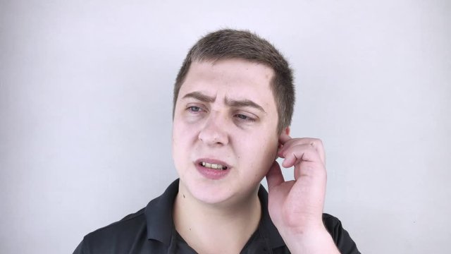 A man suffers from pain in the ear. The auditory meatus hurts due to otitis media, cerumen plug, ear boil, or trigeminal neuralgia
