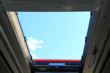 Bus sunroof . Blue sky background