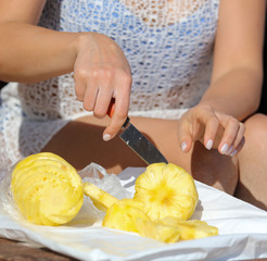 Knife sliced pineapple on a table.