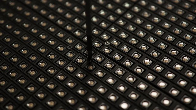 Manually unscrewing and removing screw with hand and screwdriver. Top view.