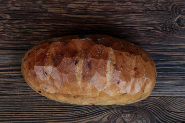 Crunchy, delicious, freshly baked bread on a wooden, rustic table. Top view.