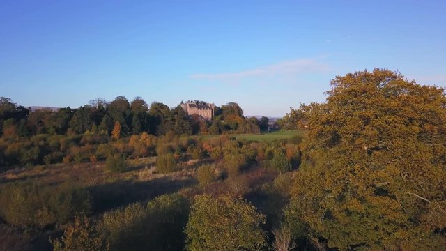 Aerial - flying forward drone view of a historic building in Airth, Scotland