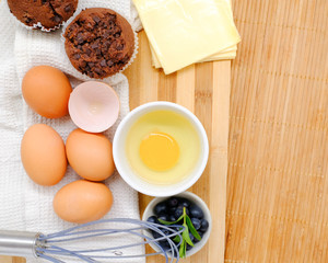 Close-up view of raw chicken eggs on wooden background
