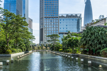 Fototapeta na wymiar modern office buildings at riverbank under blue sky in china