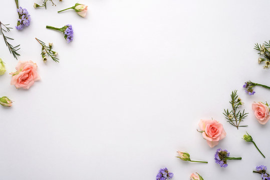 top view flower composition on white background, pink roses, eustoma, limonium in corners, flat lay, copy space