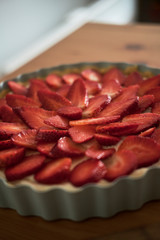 Delicious strawberry tart on wooden background