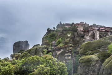 Fototapeta na wymiar Foggy landscape of Mysterious hanging over rocks monasteries of Meteora, Greece