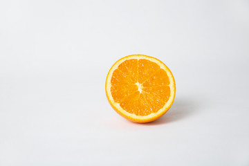 Cut orange half, fruit cutout isolated on white background. Closeup shot. Healthy nutrition or organic food concept