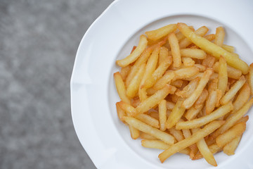 French fries in white plate.