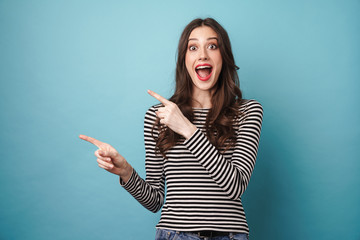 Photo of excited nice woman in striped sweater pointing fingers aside