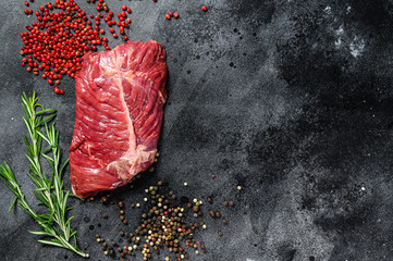 Top blade steak, raw meat, marbled beef . Black background. Top view
