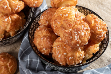 Chouquette, french choux pastry on wooden table
