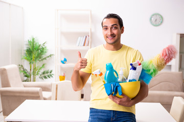 Young male contractor doing housework at home