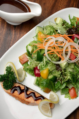 organic mixed vegetable salad with salmon fillet and balsamic vinaigrette