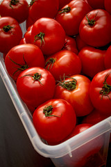 many ripe red tomatoes of different sizes