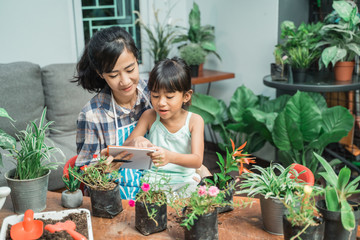 mother and daughter gardening and studying activity at home together