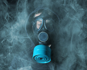 Man in a gas mask in the smoke