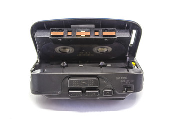 opened gray old audio tape portable player with audio cassette on white isolated background. vintage music concept