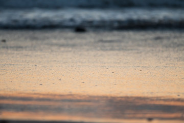 sand on the beach as the sea water recedes at sunset with soft focus and blurry background concept Summer holiday