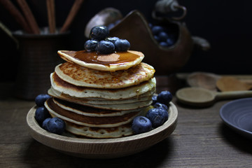 national dish pancakes, pancakes, pita with blueberries, linen napkin, poured with honey, concept of traditional cuisine