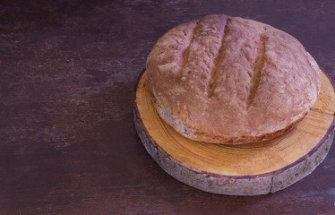 Baked homemade bread on a wooden cutting board. Homemade pastries. Baking.