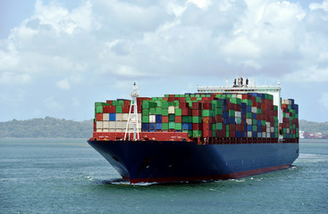 Large container ship sailing through Gatun Lake during her transit through Panama Canal. 