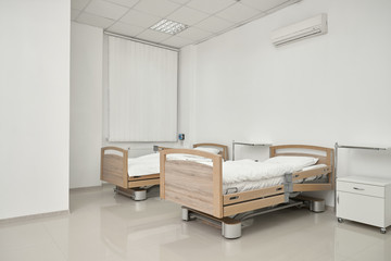 Two couches in spacious hospital room.