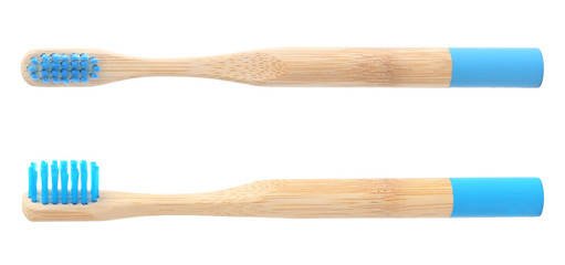 Bamboo toothbrushes with blue bristles on white background