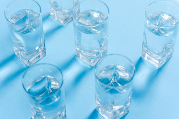 glasses with water on blue background. clean water concept