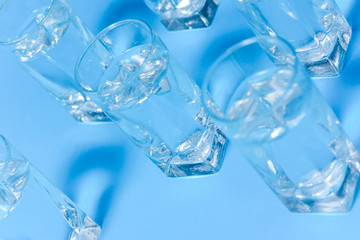 Glasses of clean water on color background