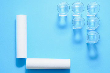 Water filters. Carbon cartridges and glasses on a blue background. Household filtration system.