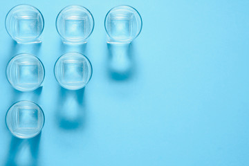 Water filters. Carbon cartridges and glasses on a blue background. Household filtration system.