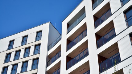 Fototapeta premium Residential Building on sky background. Facade of a modern housing construction with of balconies.