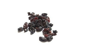 Raisins isolated on white background. Heap of dried red grapes