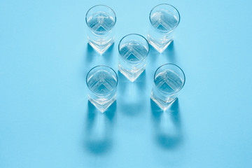 glasses with water on blue background. clean water concept