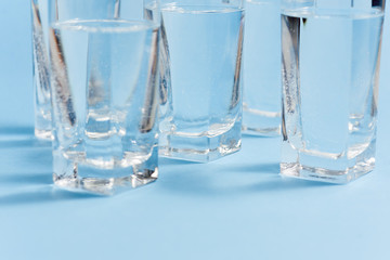 Glasses of water on blue. Close up. Copy space. Water balance for healthy and detox.
