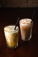 Banana and kiwi cocktail with ice on a wooden background