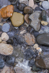 sea pebbles on a rocky beach in Sunny summer day