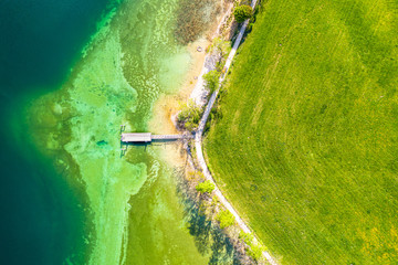 Top view aerial drone photo of stunning colored lake Tegernsee beach with crystalline water. Aerial from above