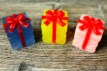 Blue, yellow and pink gift with red ribbon. Handmade soap.