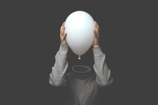 surreal man without head holding white balloon