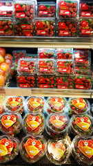 Fototapeta na wymiar Strawberries in plastic boxes at the grocery store counter